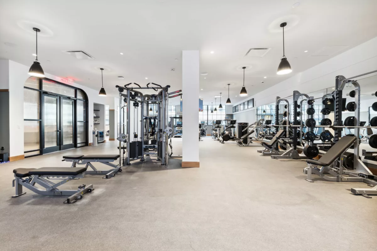 Fitness center with white walls and strength and cardio equipment
