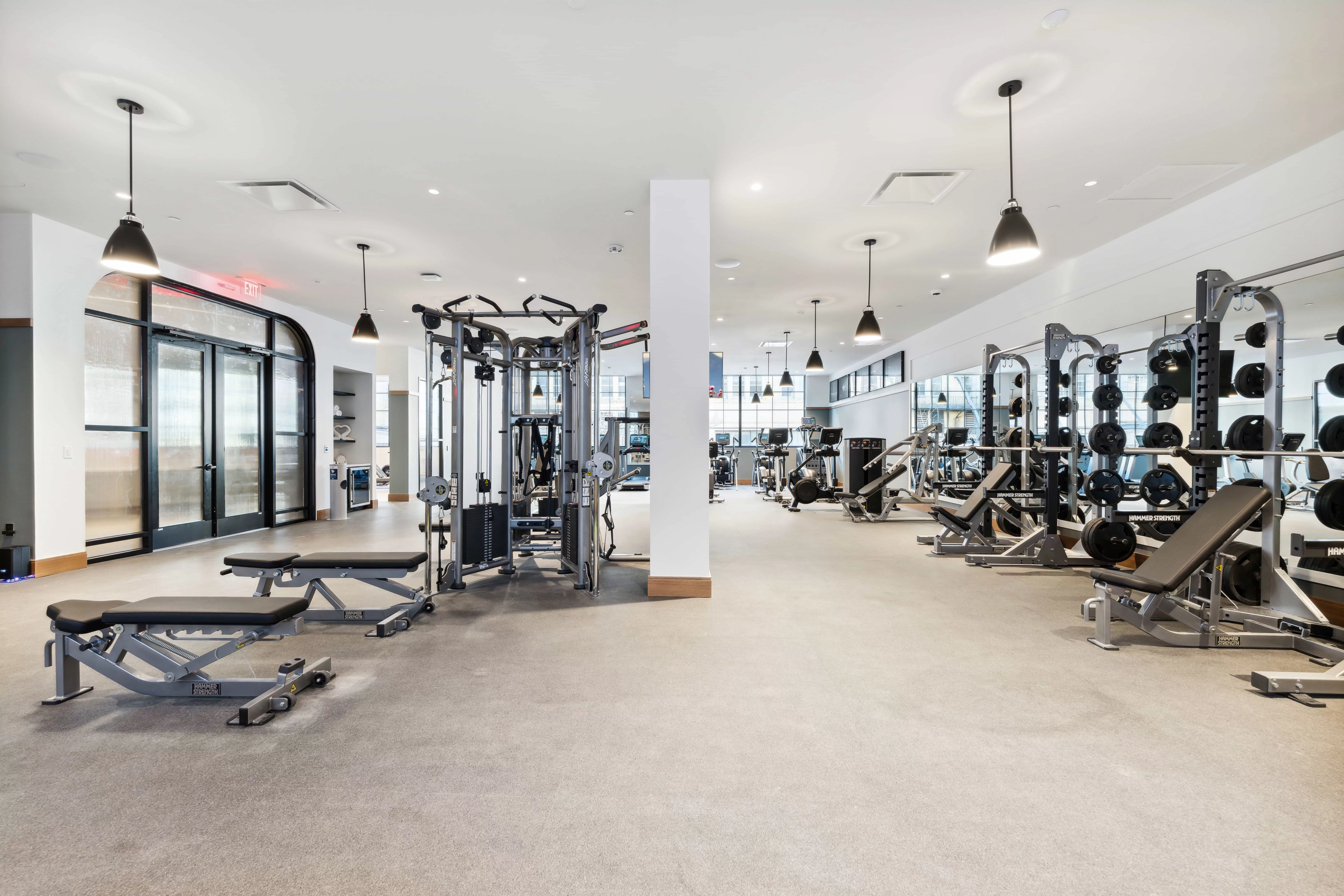 Fitness center with white walls and strength and cardio equipment