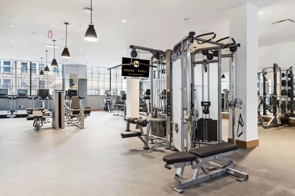 Fitness center with white walls and strength and cardio equipment