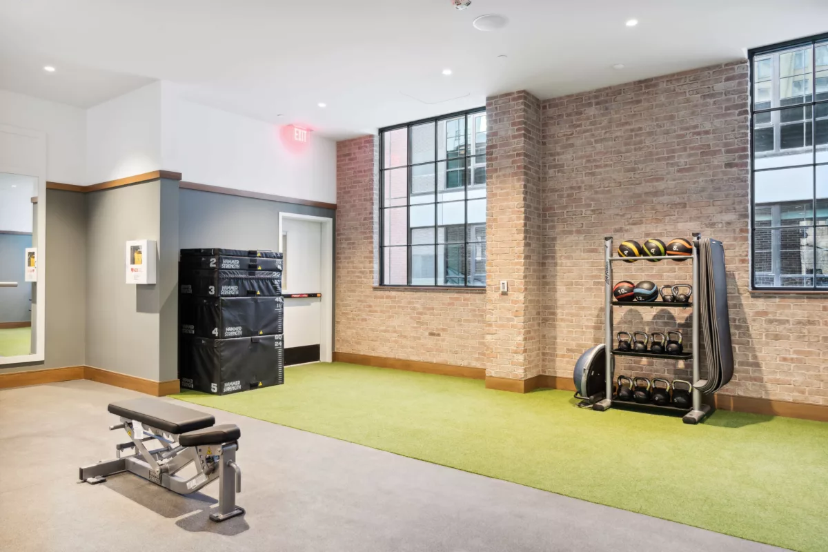 Fitness center with brick wall and turf area for training