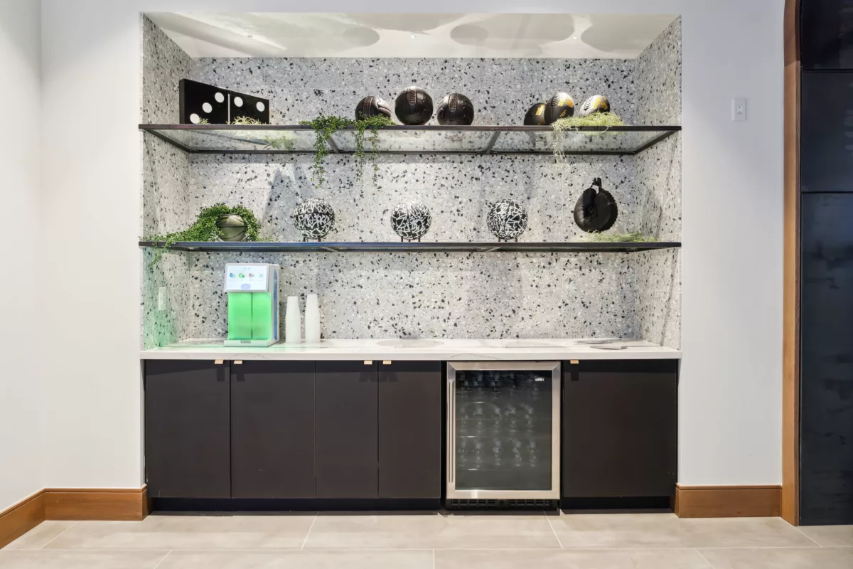 Hydration bar outside of fitness center with flavored water machine and fridge with water bottles