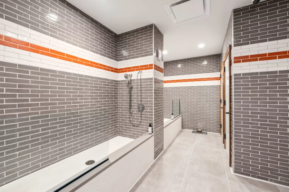 Pet spa with gray tiles walls and cleaning areas and showers