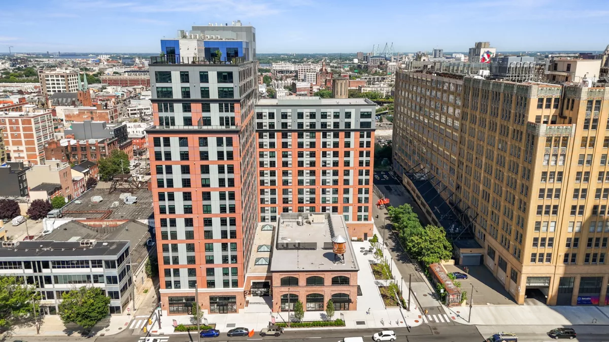 Exterior of Broad + Noble, an 18-story apartment building with a brick exterior